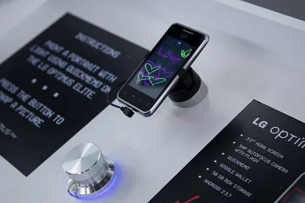 A phone running a drawing app in a phone holder.