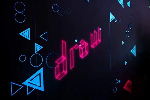 A projected prompt that says Draw.