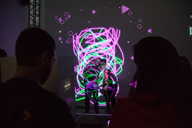 Two people with colorful lines projected on top of them.