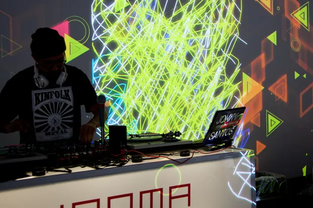 A DJ playing in front of projections.