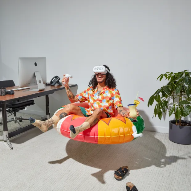 A man floating in a real life inner tube wearing a VR headset